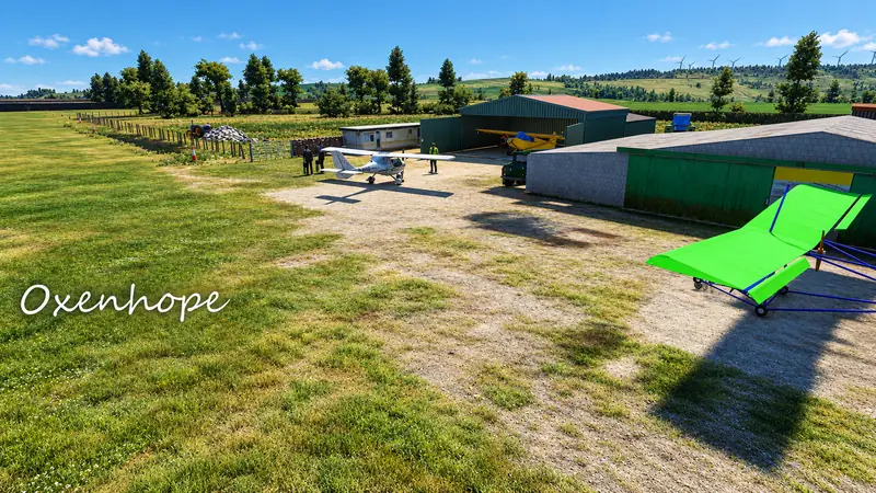 Light aircraft and microlight by the hangars at Oxenhope farm strip in Microsoft Flight Simulator